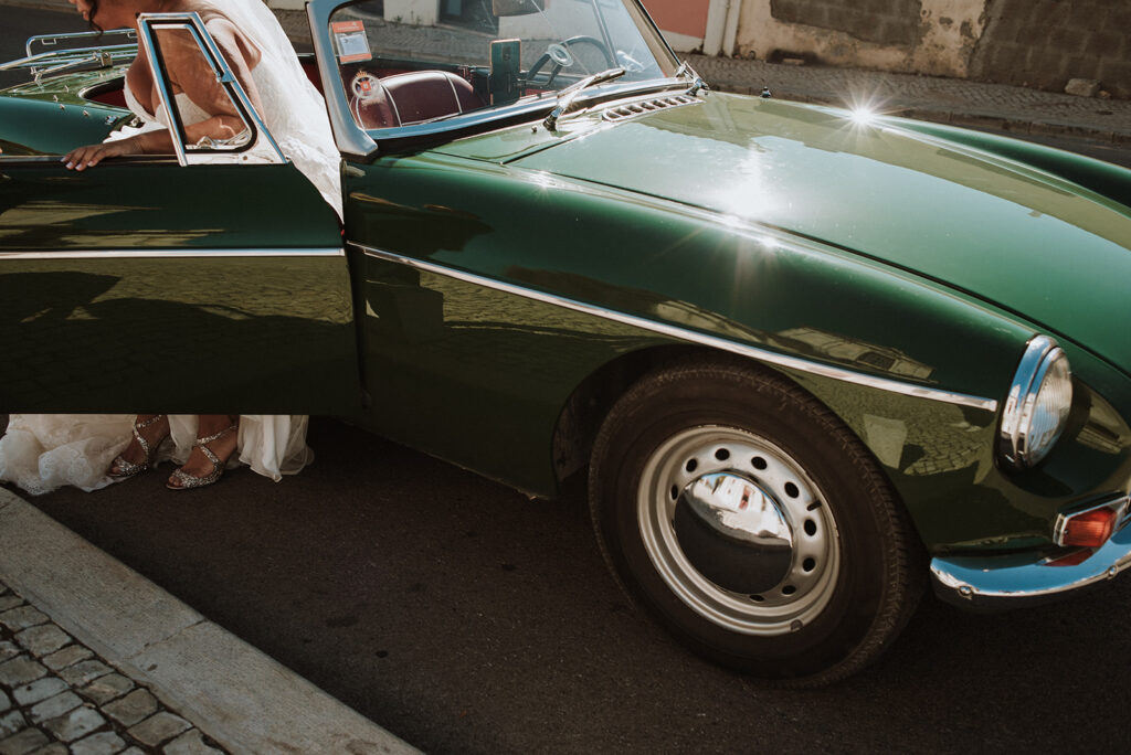 Bride arriving in a classic car during an intimate wedding in Lisbon, Portugal.