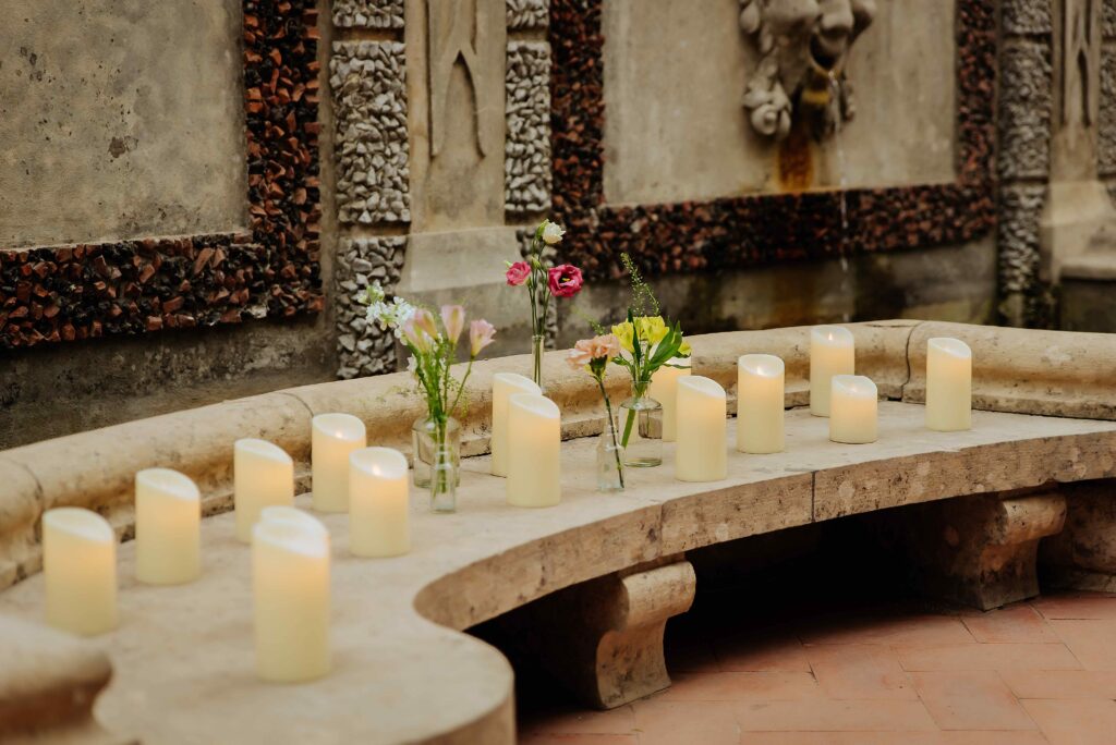 Micro wedding in Portugal with candlelight ceremony setting and floral details in a historic space