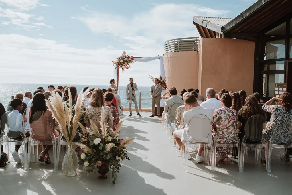 Outdoor wedding ceremony in Portugal overlooking the ocean during the wedding season