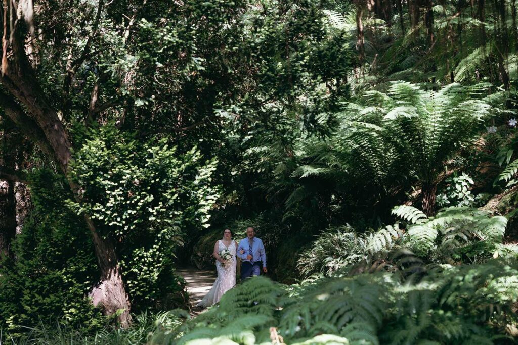 Couple walking through a lush garden estate during a destination wedding in Portugal