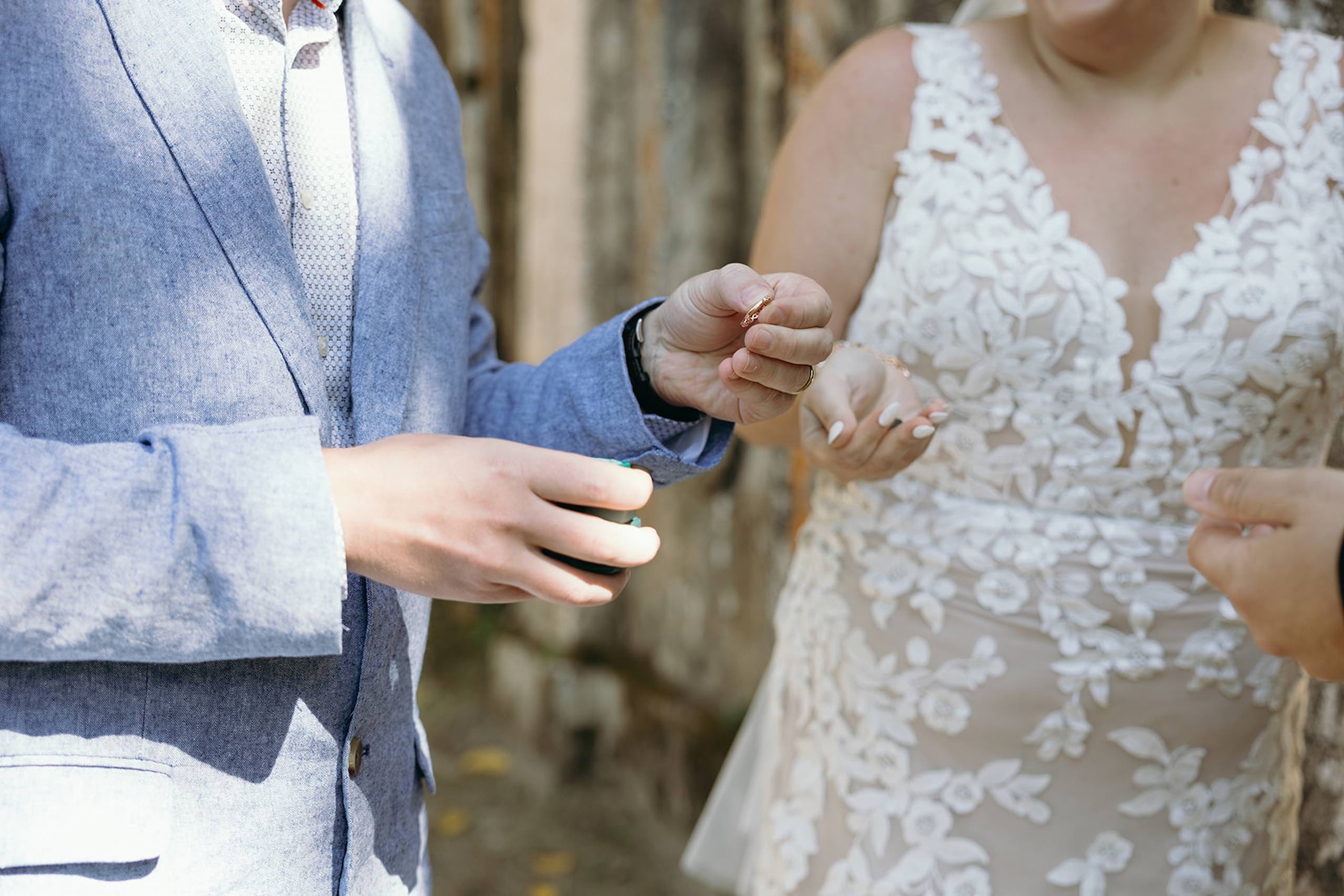 Couple exchanging wedding rings during an intimate destination wedding ceremony in Portugal