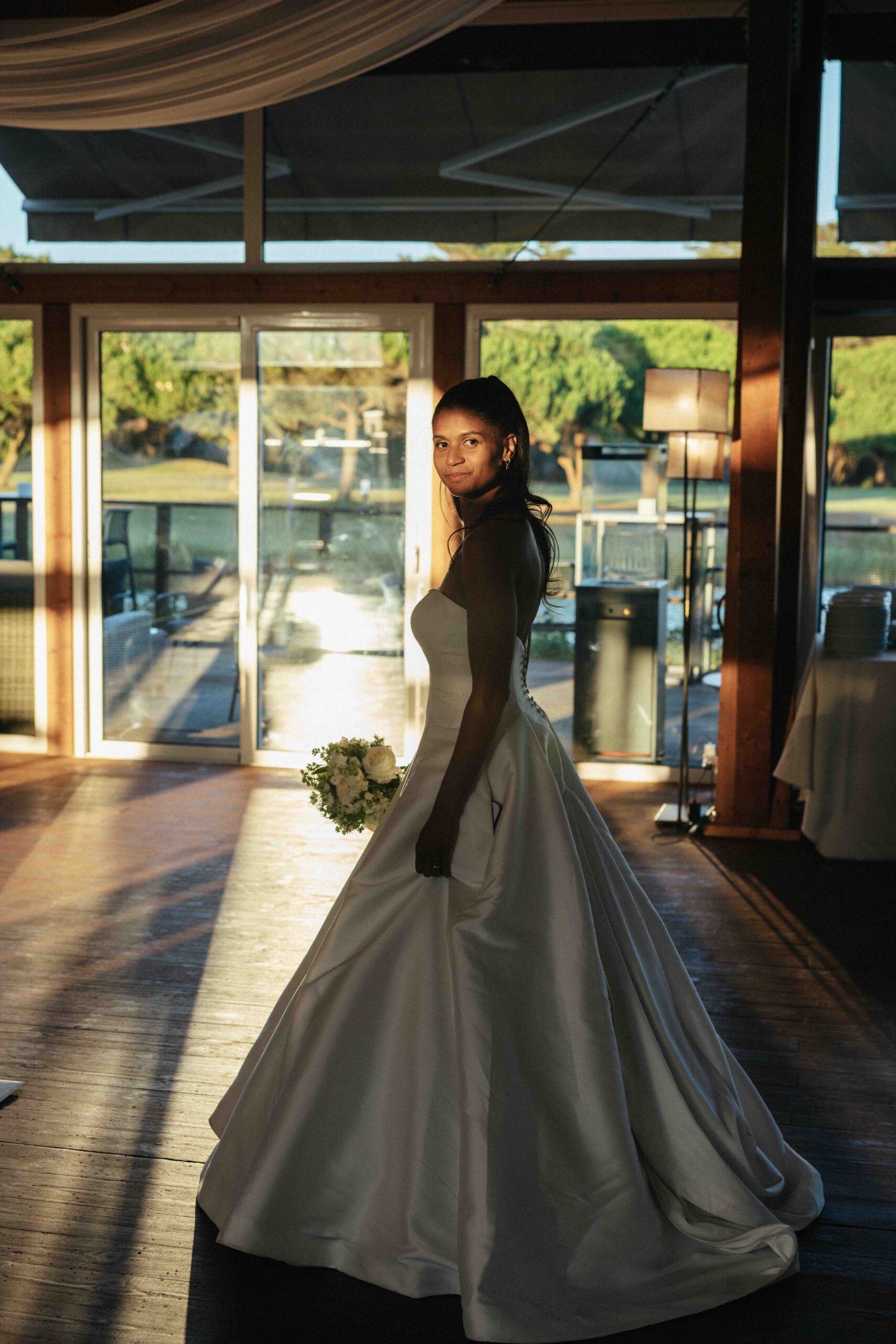 Bride walking through an elegant wedding venue in Lisbon during a destination wedding celebration.