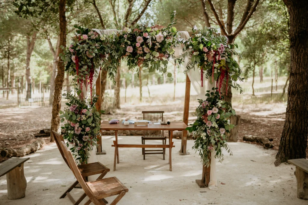 Outdoor wedding ceremony setup at a wedding venue in Portugal surrounded by pine trees.