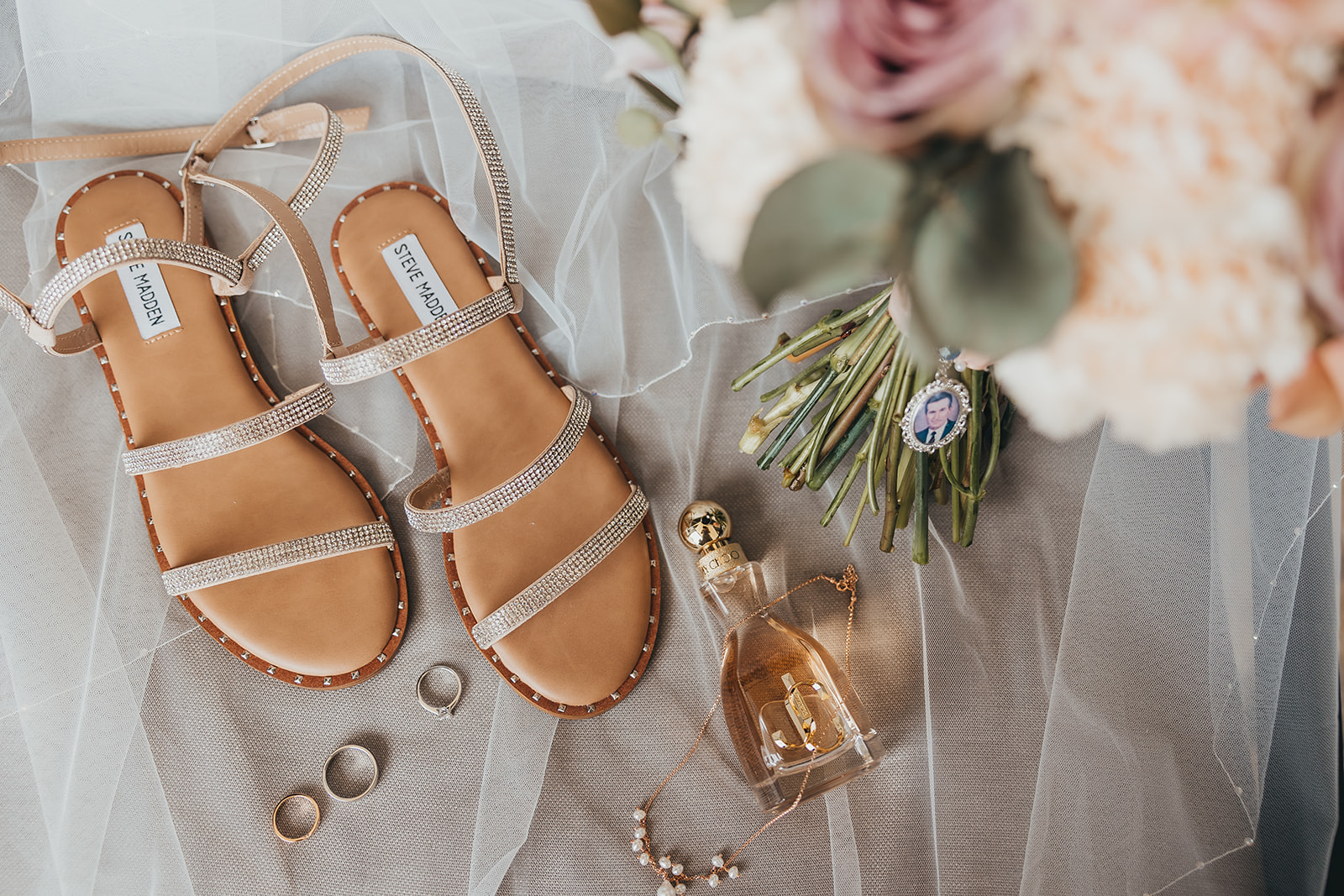 Bridal accessories prepared for a destination wedding in Portugal, including wedding shoes, bouquet, rings and perfume.