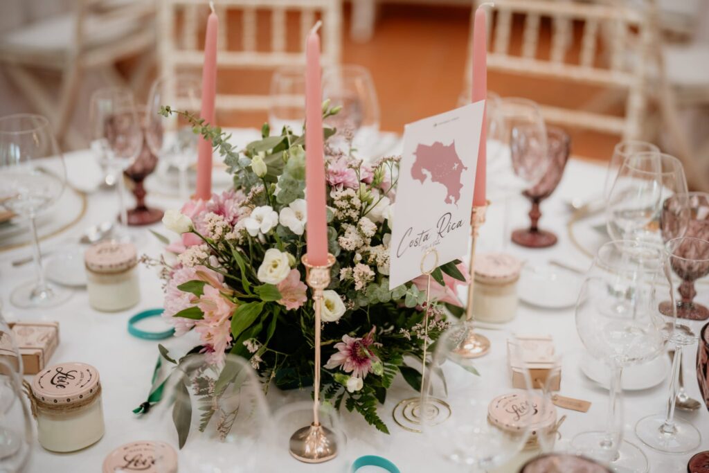 Wedding reception table styling with floral centrepiece and personalised décor at a destination wedding in Portugal.