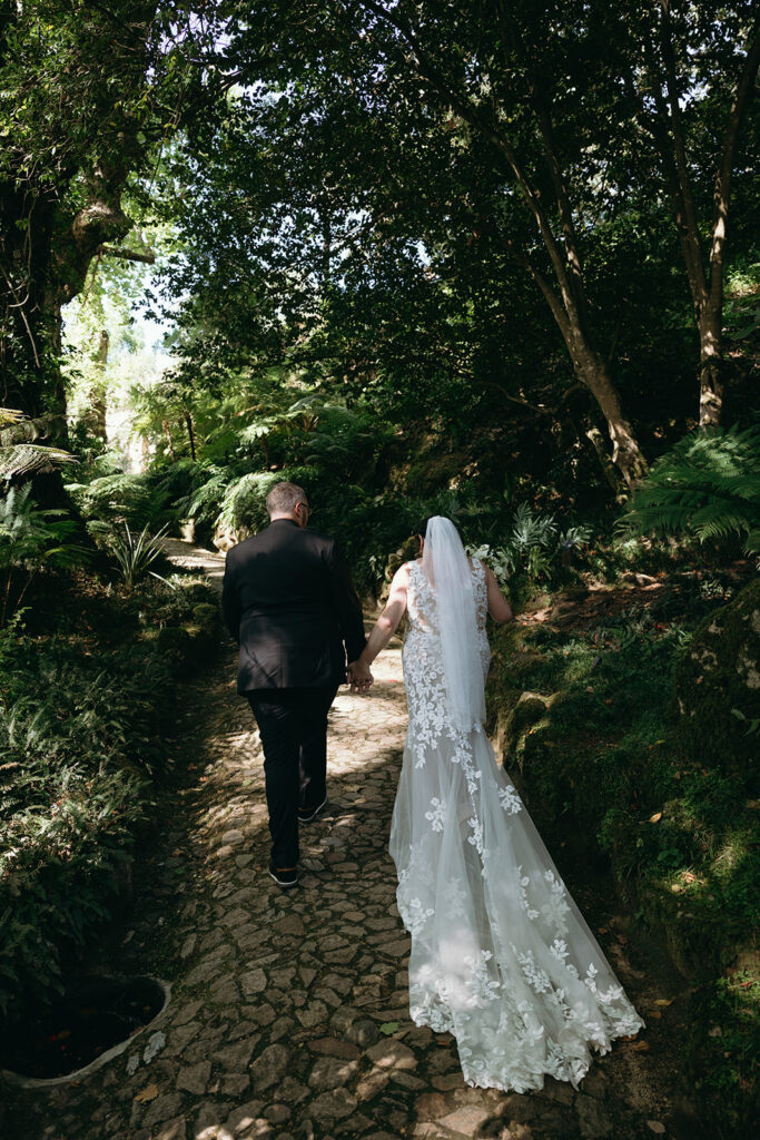 Wedding couple walking through the gardens of Monserrate Palace in Sintra