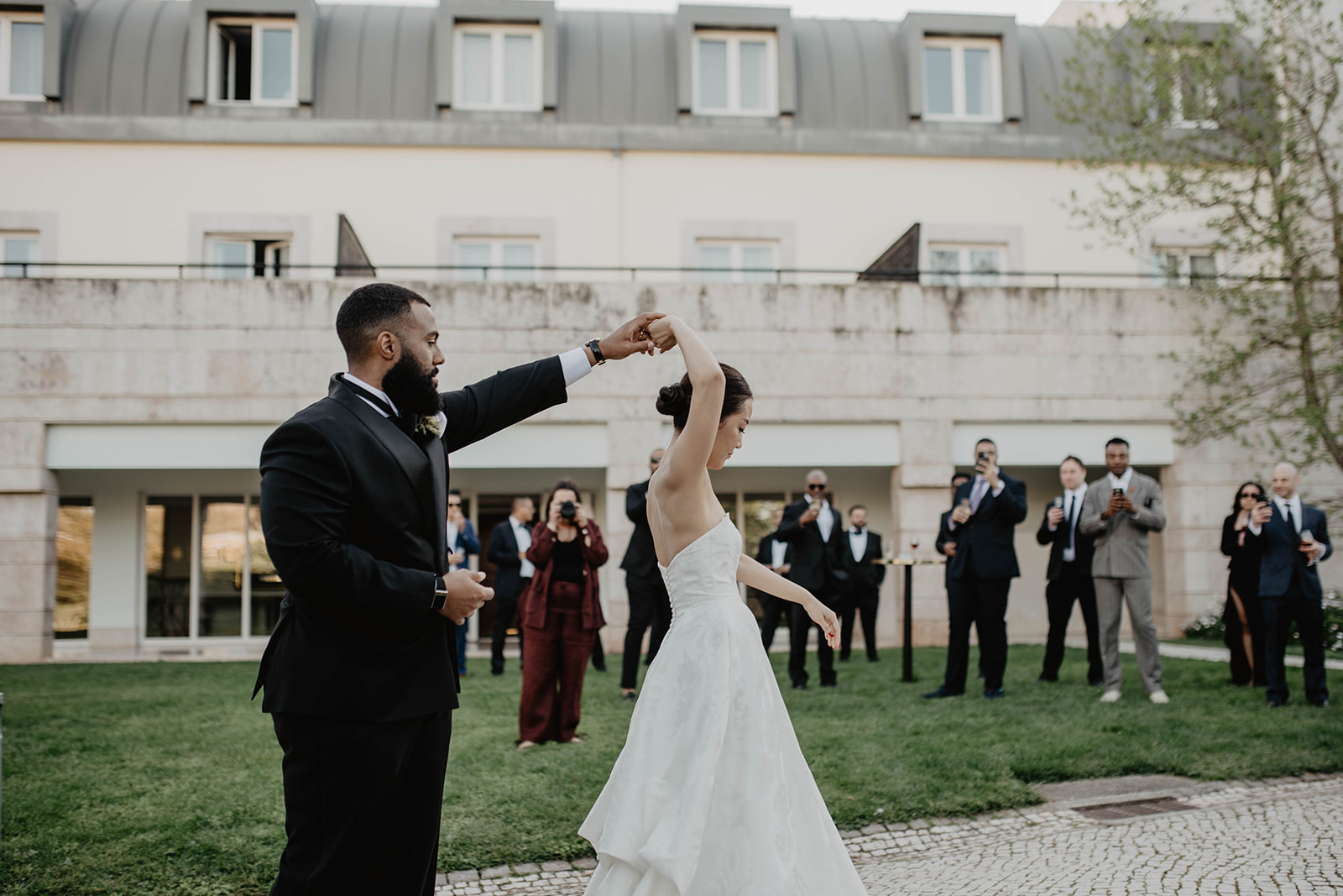 Bride and groom dancing in the gardens at a Pestana Palace wedding in Lisbon